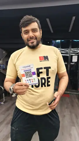 Supplement store owner holding a SaathiX QR card