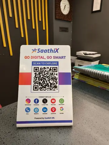 Close-up of a SaathiX acrylic QR code stand on a shop desk