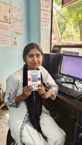 Business owner holding a SaathiX QR card