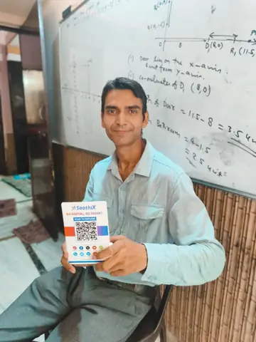Coaching institute teacher showing the SaathiX QR stand